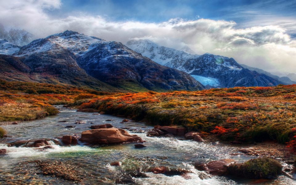 Download View Across River Leading To Mountains wallpaper