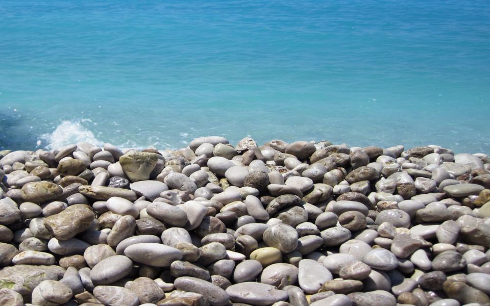 Download Pebble Beach And Sea wallpaper