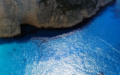 Bright Blue Water And Cliff