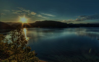 Sun Over Mountains Onto Lake
