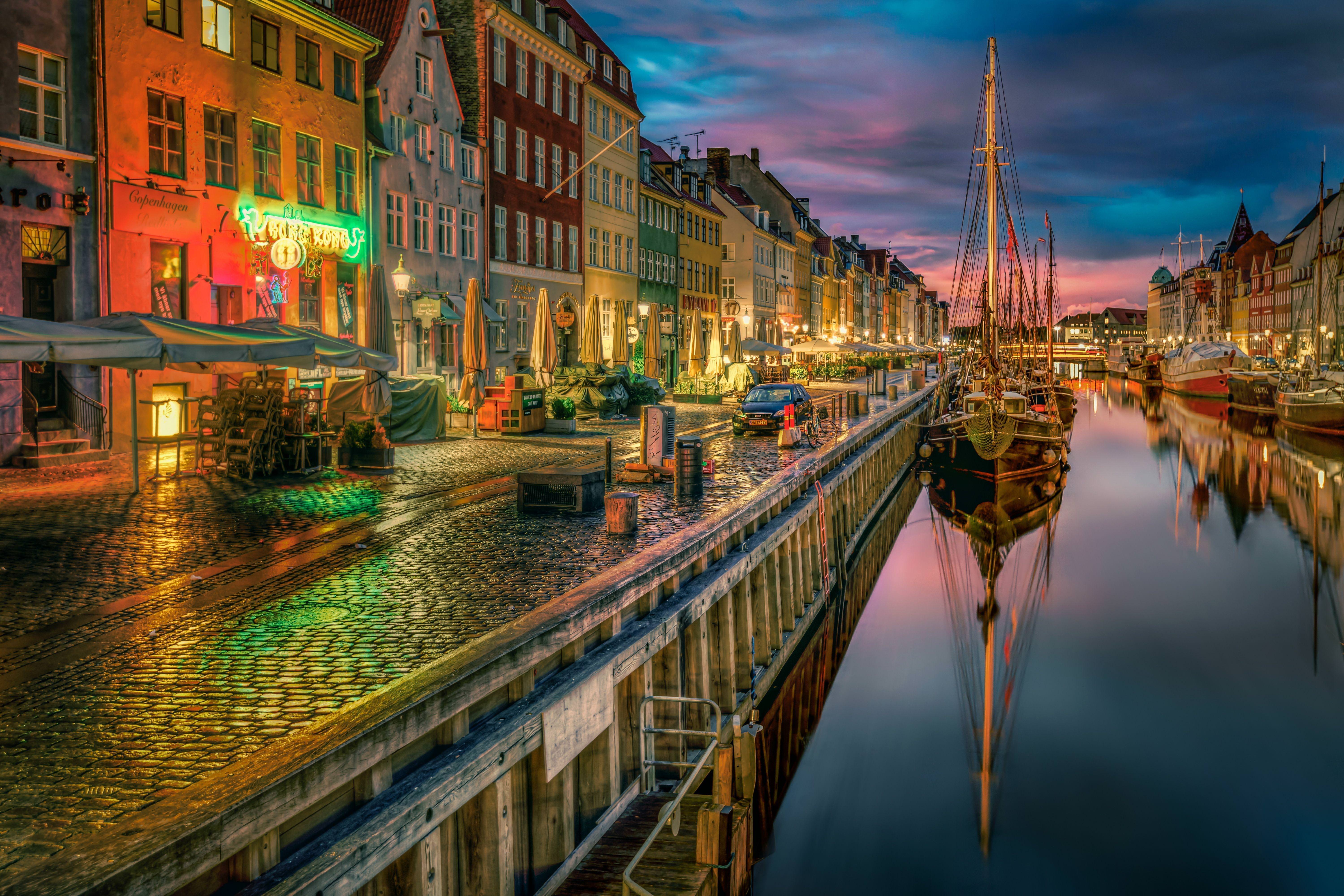 Premium Photo | Copenhagen, denmark. september 10, 2021. famous nyhavn pier  with colorful buildings and boats in copenhagen during magical sunset. most  popular place in copenhagen.